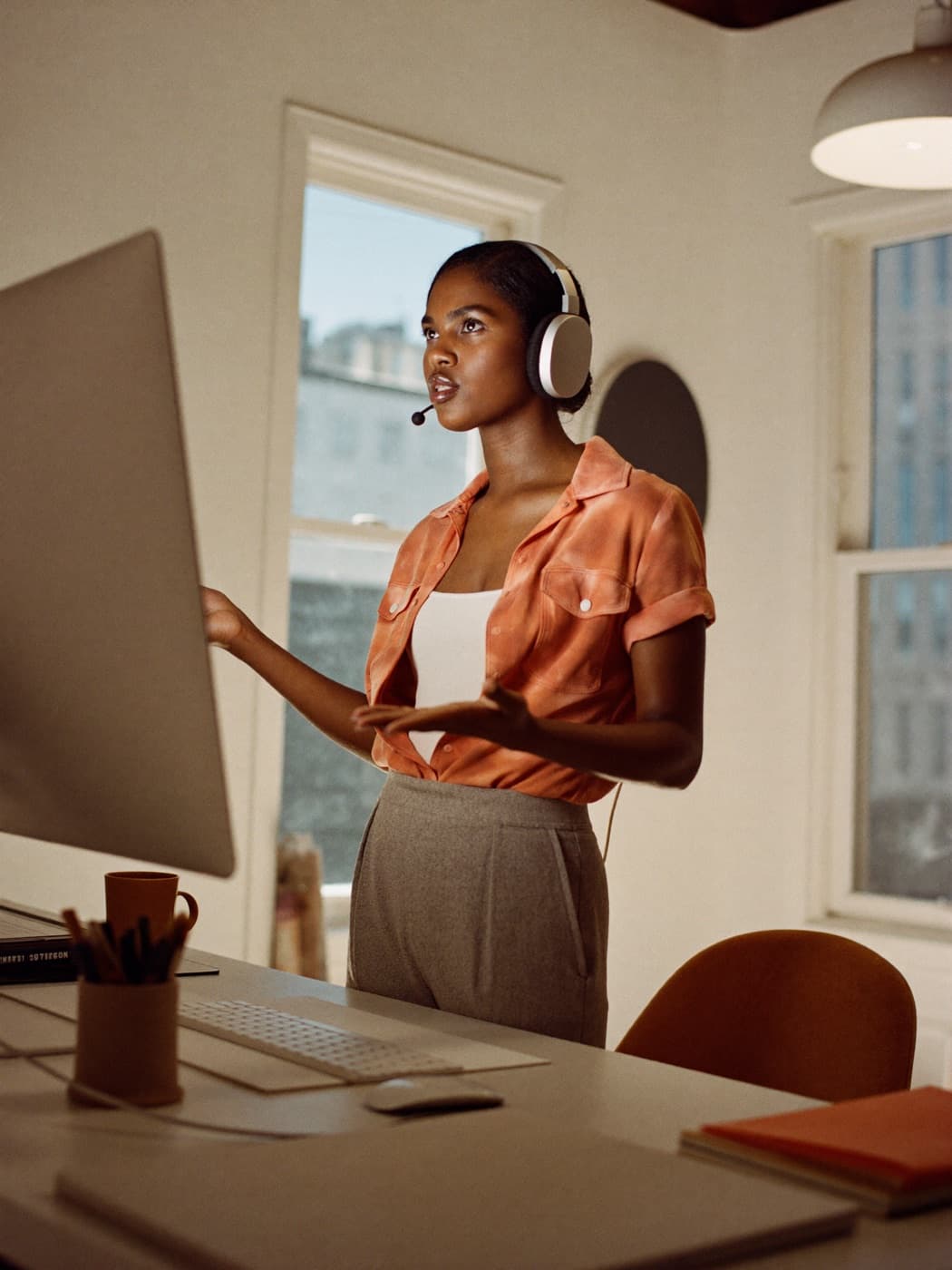 Sales specialist on a headset call at a desk